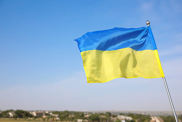 National flag of Ukraine against blue sky. Space for text - 写真・画像