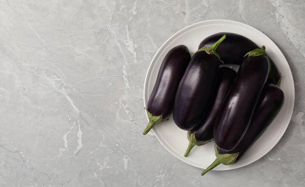 Raw ripe eggplants on grey table, top view. Space for text - Foto, Imagen