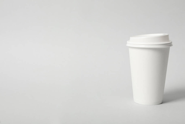 Takeaway paper coffee cup on light grey background. Space for text - Fotó, kép
