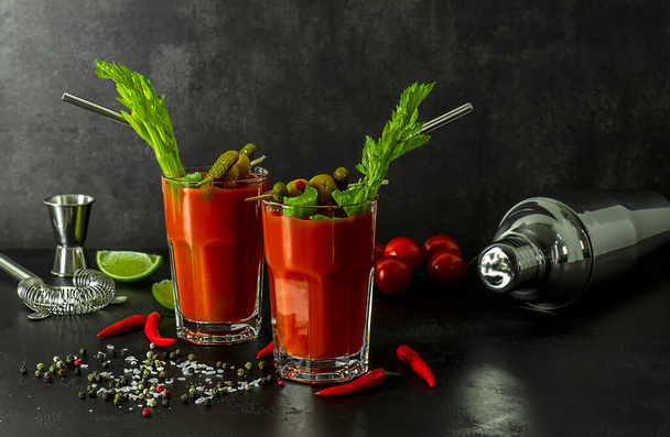 Bloody Mary Cocktail in glasses with garnishes.  - Photo, Image