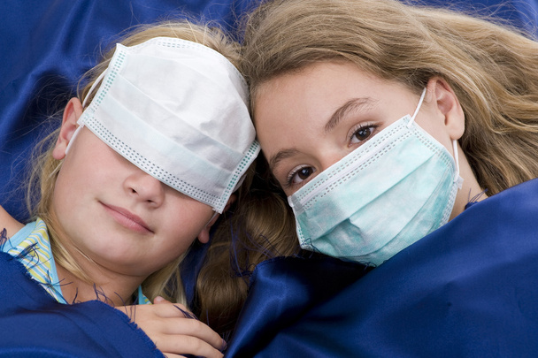 Sisters in bed with protective mask - Photo, Image