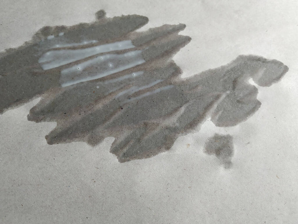 Closeup of Milk dropped above the Flattened paper it wets and absorb create abstract shape - Photo, Image