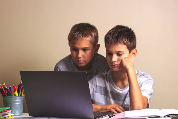 Learning difficulties, school, remote education, online learning at home. Two kids using laptop computer - Photo, Image
