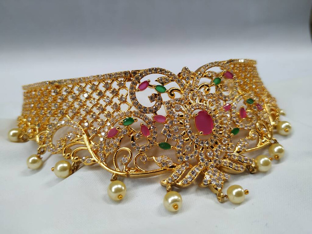 Closeup of Indian wedding polki necklace choker, Earring, tikka and other jewelry accessories for bride isolated on white Background - Photo, Image