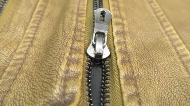 The zipper opens on the brown leather jacket. - Filmmaterial, Video