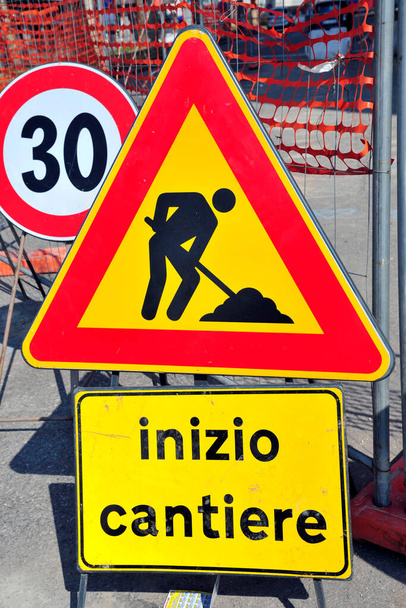 road sign with a warning symbol on the ground - Photo, Image