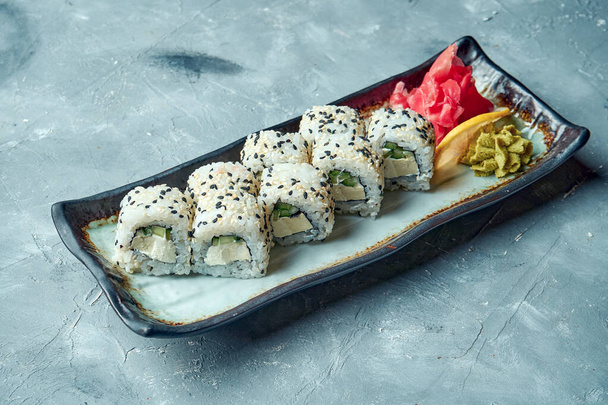 California sushi roll with cream cheese plate on a gray background. Japanese food - Φωτογραφία, εικόνα