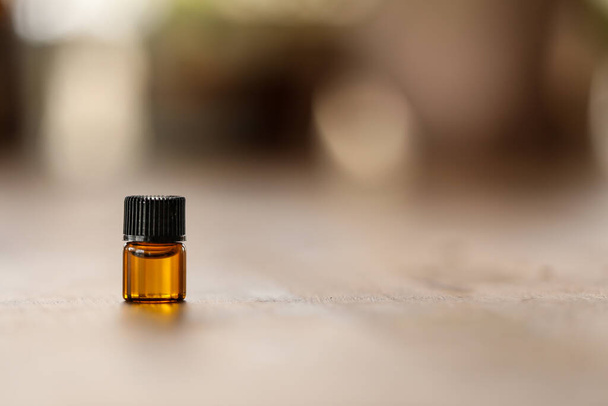A shallow focus shot of an essential oil bottle on a table - Fotó, kép