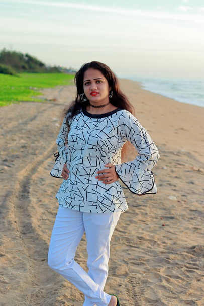 portrait plein air corps complet d'une jeune femme modèle indienne élégant posant avec fond de paysage de plage - Photo, image
