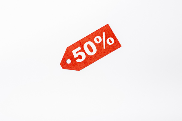 Top view of red price tag with fifty percent signs on white background - Photo, Image