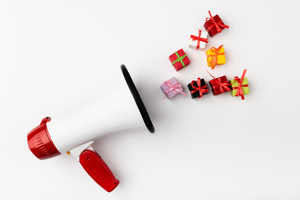 Top view of loudspeaker and small gift boxes on white background - Photo, Image