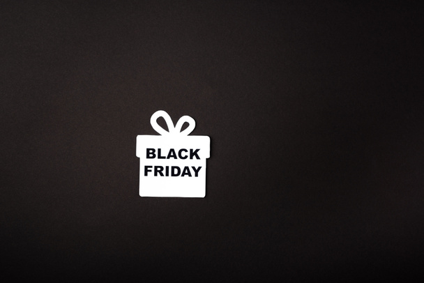 Top view of paper gift box with black friday lettering on black background  - Photo, Image