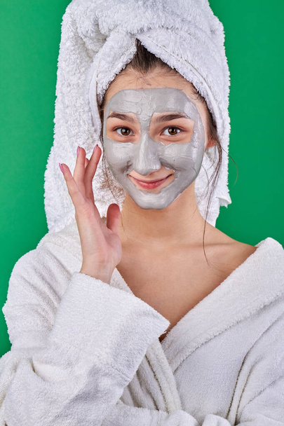 Smiling young woman with healing face mask. - Photo, Image