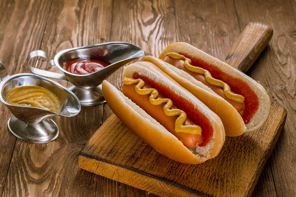 two classic hot dogs with ketchup and mustard - Foto, imagen