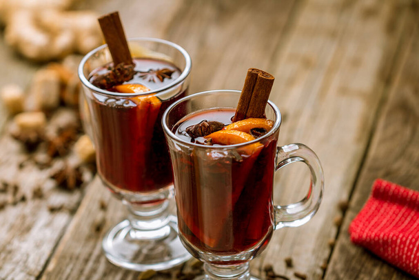 Mulled wine on old wooden background - Фото, изображение