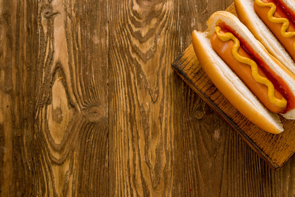 three classic hot dogs with ketchup and mustard - Fotoğraf, Görsel
