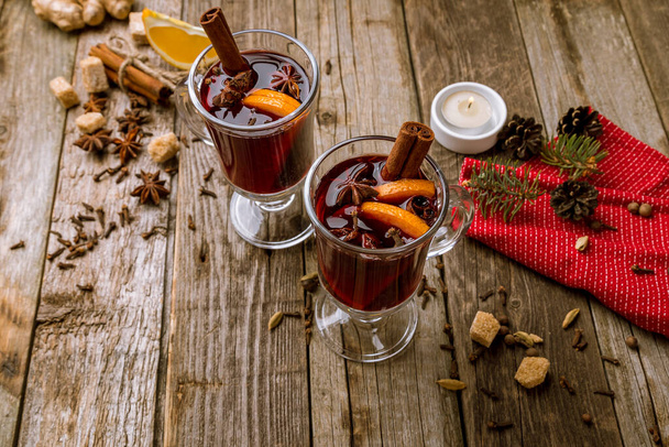 Mulled wine on old wooden background - Фото, изображение