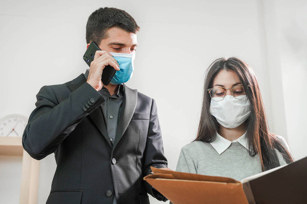 Coronavirus. Business workers wearing protective mask in a white background. Business workers with face masks back to work in office after lockdown. Small company concept. - Fotoğraf, Görsel