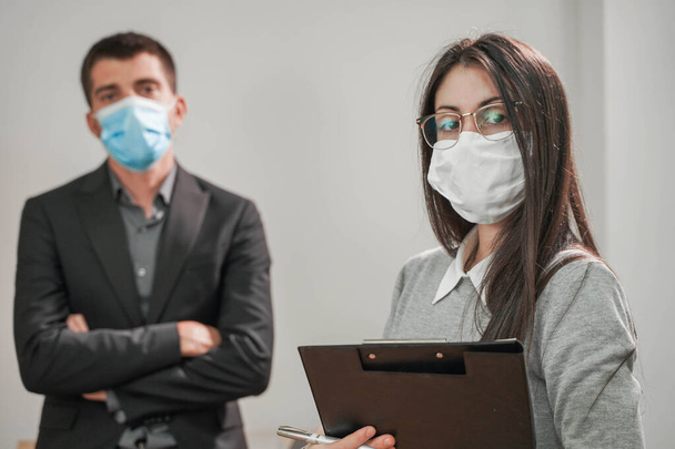 Coronavirus. Business workers wearing protective mask in a white background. Business workers with face masks back to work in office after lockdown. Small company concept. - Foto, Imagen
