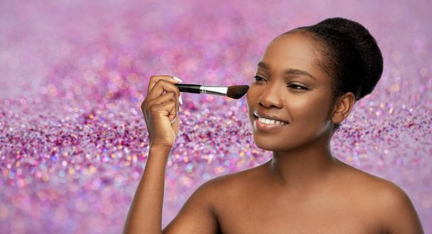 woman with make up brush applying blush to face - Фото, зображення