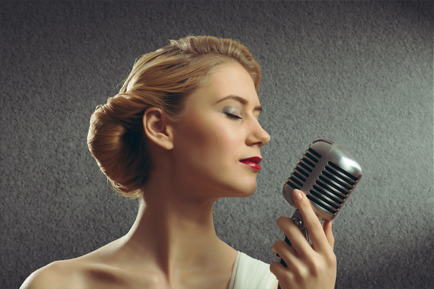 attractive female singer with microphone - Valokuva, kuva
