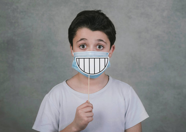 kid with medical and smile false on stick over gray background - Photo, Image