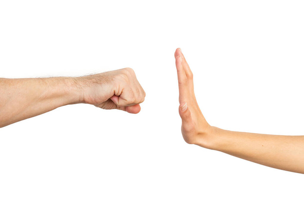 Woman hand stoping a man fist on a white background. Gender Violence - Photo, Image