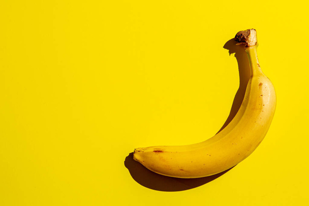 Banana fruit on background of yellow. Concept of freshness and healthy food. - Φωτογραφία, εικόνα