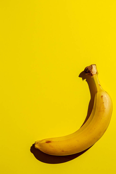 Banana fruit on background of yellow. Concept of freshness and healthy food, vertical. - Zdjęcie, obraz
