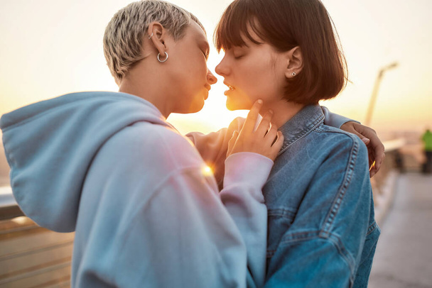 Young lesbian couple having romantic moment, Two women going to kiss while watching the sunrise together, Selective focus - Photo, image