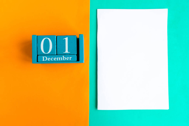 December 1. Blue cube calendar with month and date and white mockup blank on color background. - Photo, Image