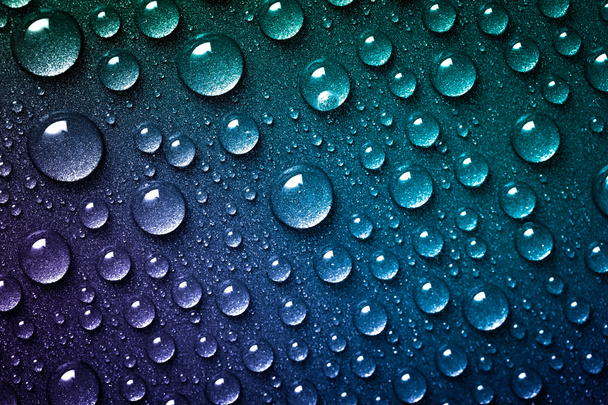 Lots of water drops splashed on a bright blue and green background. Abstract droplets close up - Photo, Image