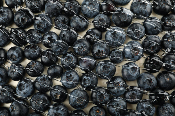 Tasty blueberry pie with syrup on whole background, close up - Photo, Image