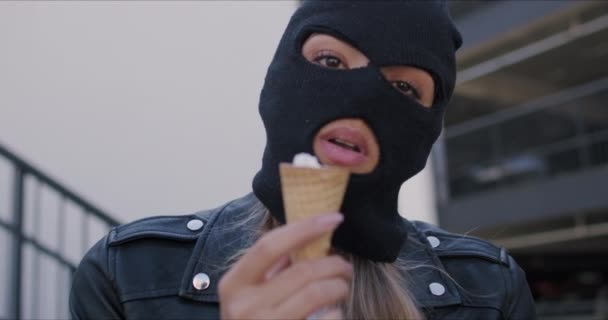 Woman wearing black balaclava and leather jacket - Filmati, video