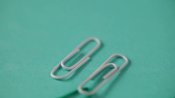 colored paper clips fall on the table. school supplies . paper clips close up - Footage, Video