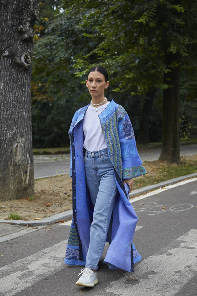 MILAN, ITALY - SEPTEMBER 25, 2020: Woman with blue coat with floral decorations before Sportmax fashion show, Milan Fashion Week street style - Foto, imagen