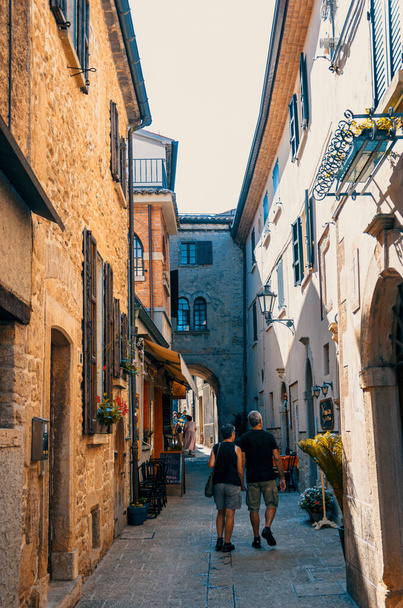 Tourists walk along the old street in San Marino - Photo, Image