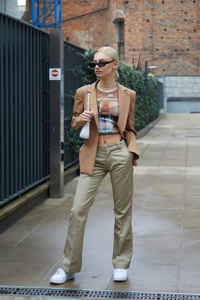 MILAN, ITALY - SEPTEMBER 24, 2020: Woman with beige jacket and sunglasses before Max Mara fashion show, Milan Fashion Week street style - Foto, Bild