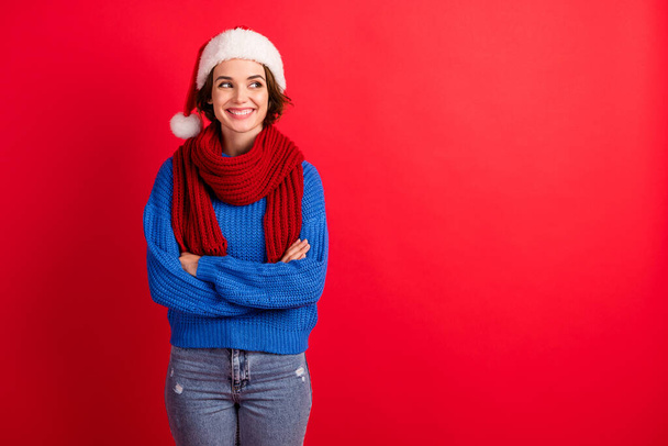Photo of positive jolly girl in santa claus cap cross hands look copyspace magic fairy miracle newyear event wear pullover isolated over bright shine color background - Fotografie, Obrázek