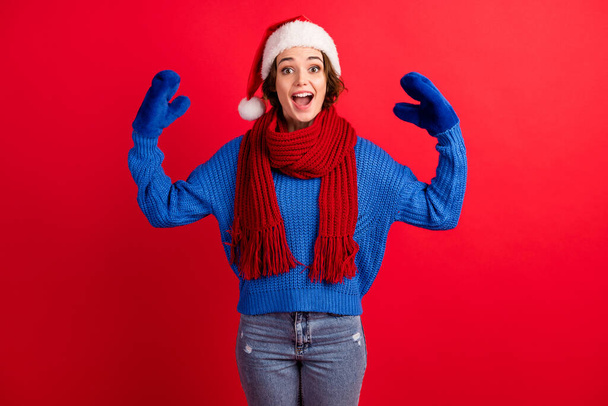 Photo of excited crazy girl in santa claus headwear raise hands imagine mittens puppet tell say communication wear sweater denim isolated over bright shine color background - Foto, afbeelding