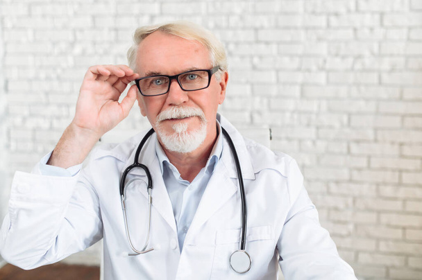 Headshot of senior male doctor, video call - Photo, Image