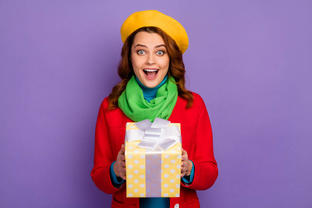Close-up portrait of her she nice-looking attractive lovely pretty cheerful cheery glad amazed wavy-haired girl holding in hands giftbox isolated over violet lilac purple pastel color background - Foto, imagen