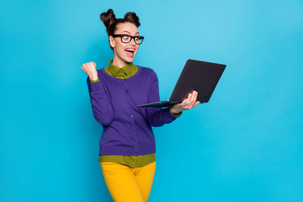 Portrait of her she nice attractive smart clever cheerful girl holding in hands laptop celebrating win winner isolated bright vivid shine vibrant blue green teal turquoise color background - Foto, Imagen