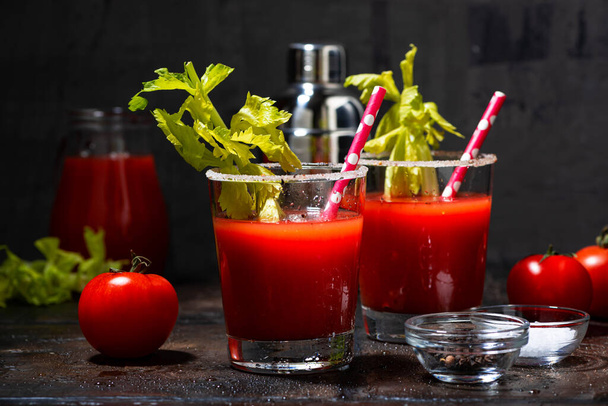 bloody mary alcoholic cocktail in glasses on dark background, horizontal - 写真・画像