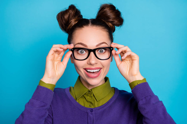 Closeup photo of attractive shocked lady two funny buns crazy good mood try on new vision specs amazed perfect view wear shirt collar violet sweater isolated blue color background - Fotoğraf, Görsel