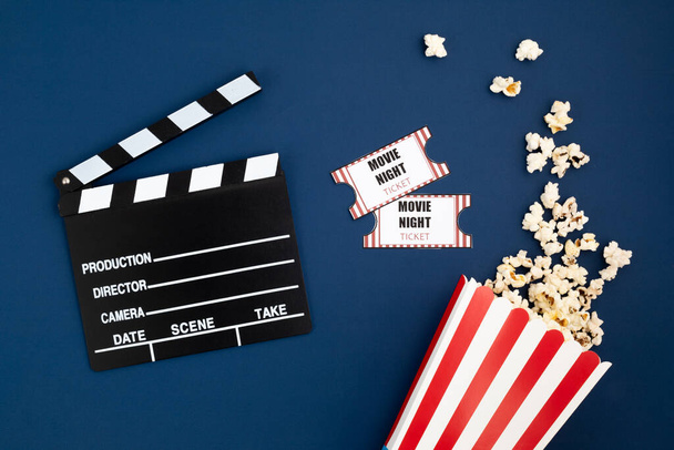 Movie clapperboard and cinema tickets. Home movie night, party invitation. Top view, copy space, mockup - Photo, Image