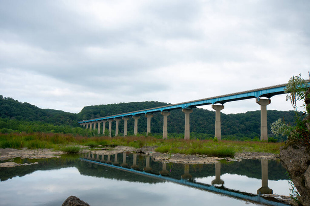 The Norman Wood Bridge OVer the Susquehanna River Reflecting Itself in a Small Body of Water on a Cloudy Day - Photo, Image