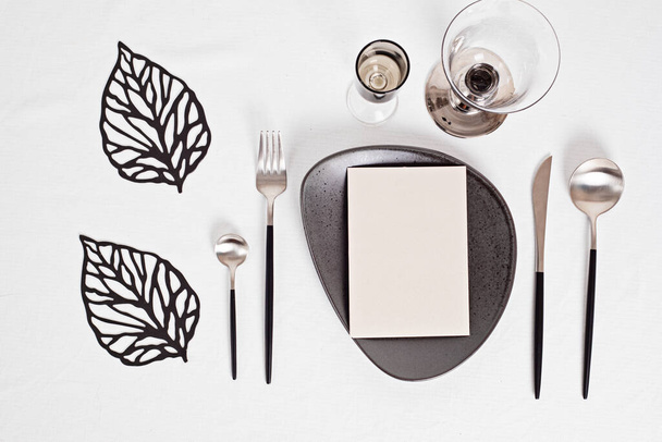 Template of Christmas table decoration with mock up of menu in minimal black and white style. Festive dinner with guest invitation card. - Photo, Image