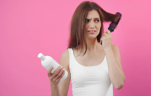 Unhappy woman brushing hair - Fotó, kép