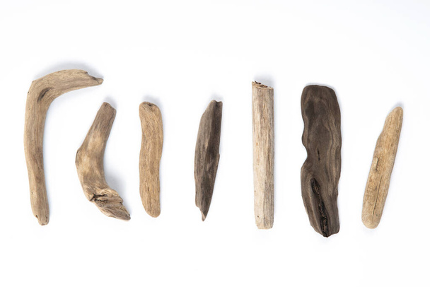 Set of different sizes and forms driftwood sticks isolated on white background. - Photo, Image